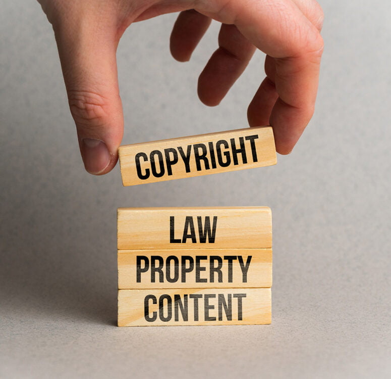 Concept Copyright And Intellectual Property On Wooden Blocks.
